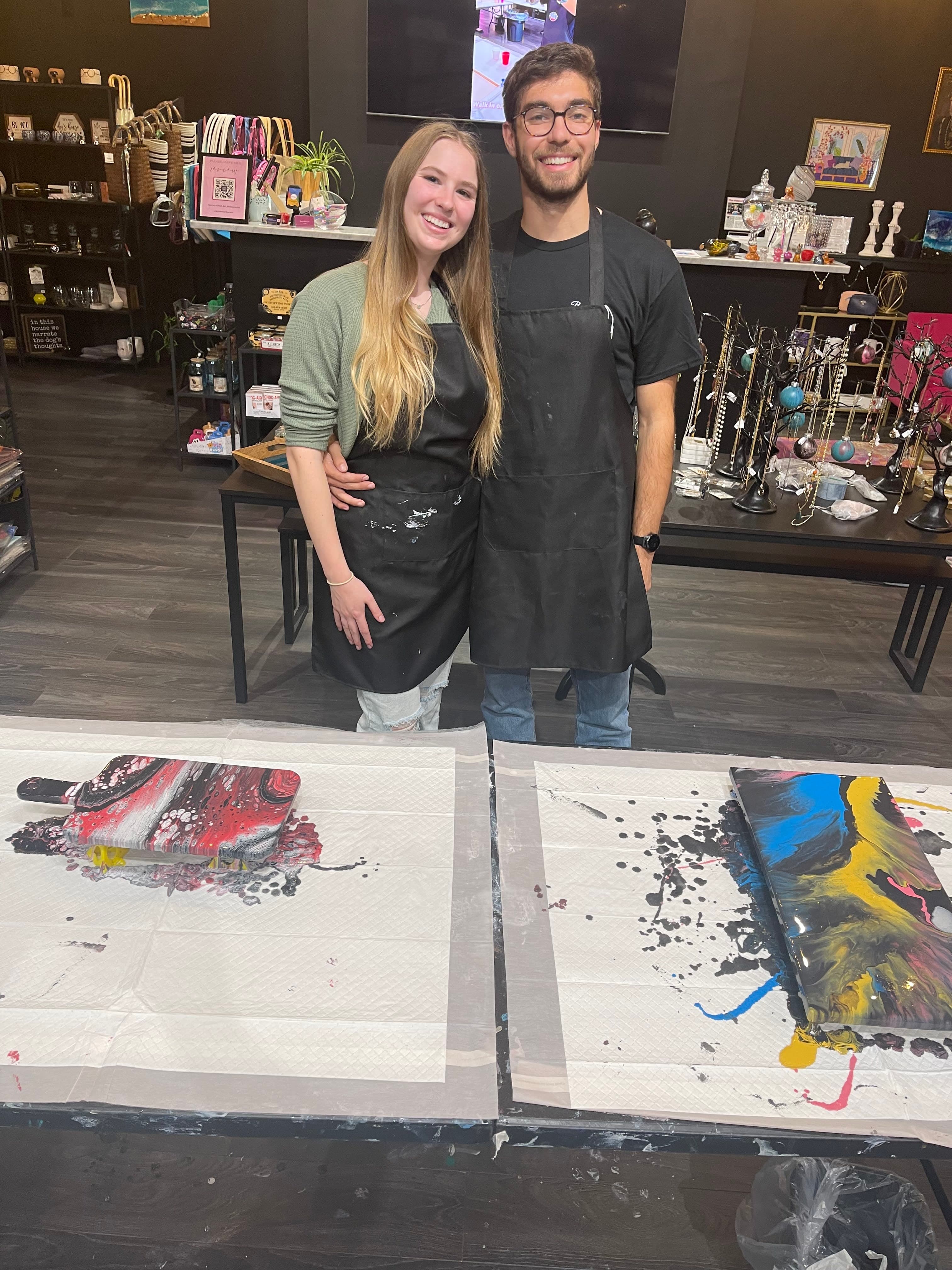 A couple enjoying a creative date night experience at ATL Fluid Art
